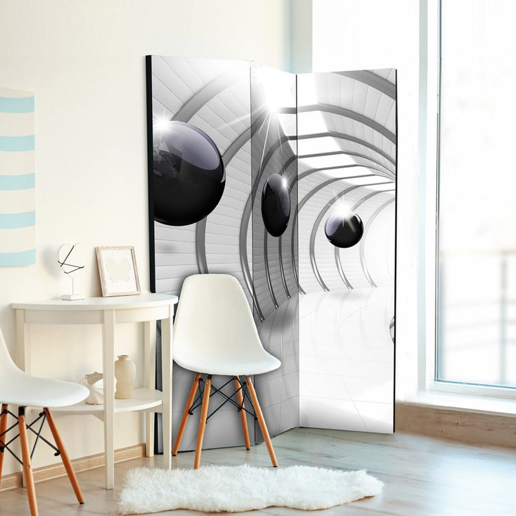 a living room next to a balcony, you can see a 3 paneled room divider with futuristic 3D design black balls and silver tunnel in the corner of the room