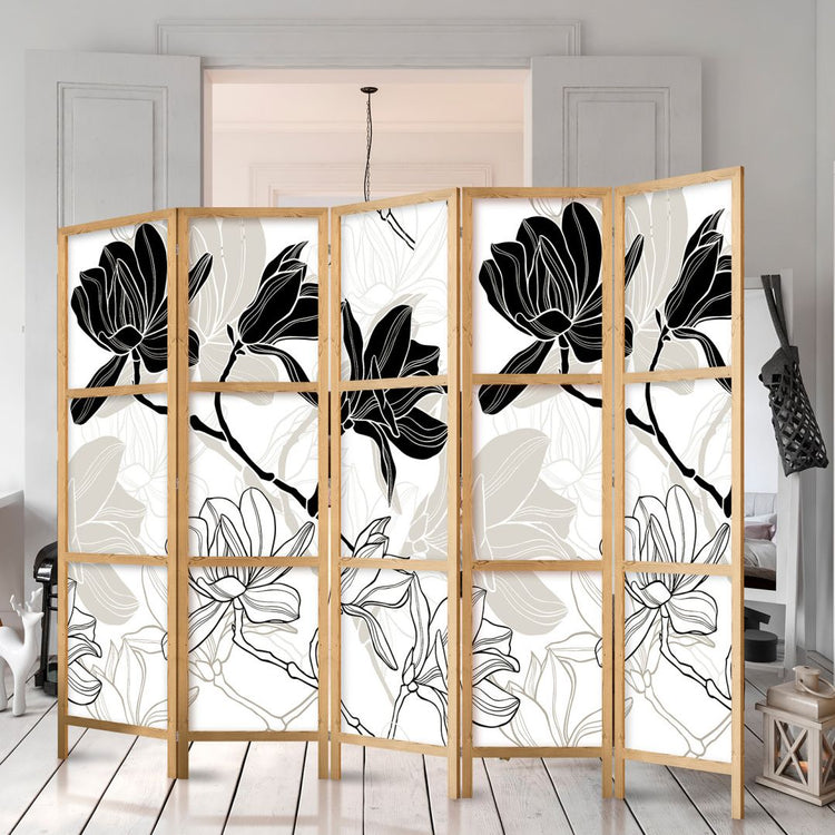 a black & white floral design printed on a shoji room divider with 5 collapsible panels, it adds privacy and style to a living room 