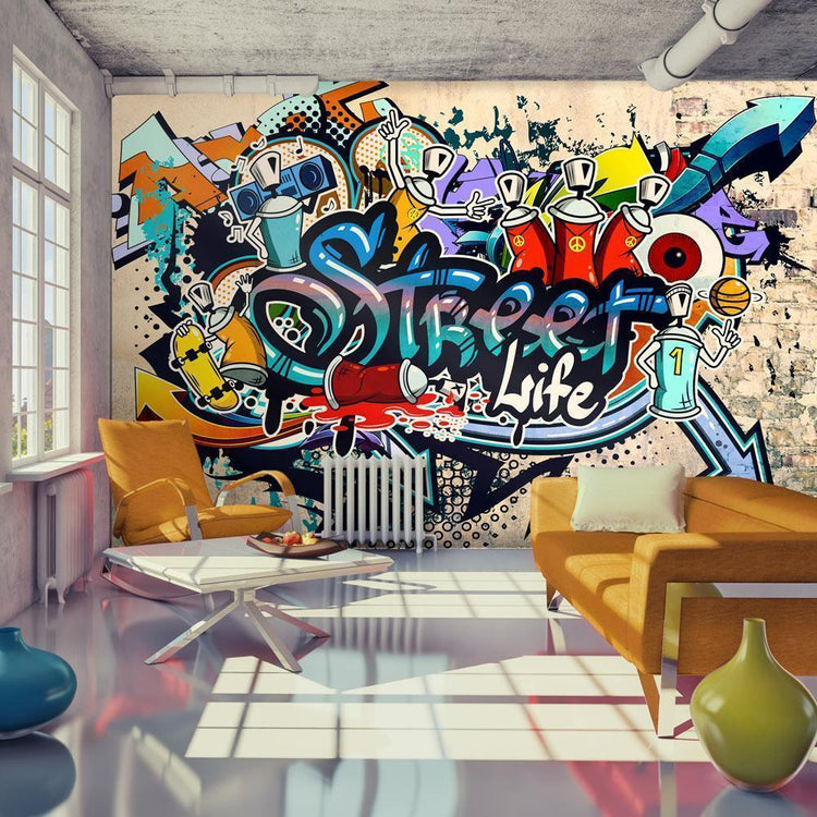 A large graffiti mural on a living room wall with colorful text and designs, the text reads: Street Life