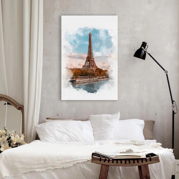 The Eiffel tower canvas print in a modern bedroom with white bed sheets