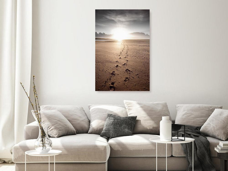 A modern living room features a large landscape canvas print depicting snow-capped mountains reflected in a calm desert. 