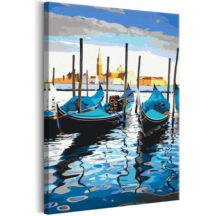 learn to paint canvas showing a beautiful image of boats and a coastal city behind it, a mix of blues oranges and yellows