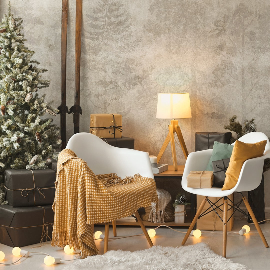 a living room decorated for christmas and a minimal design wallpaper mural mounted on the wall in the background, you can clearly see some trees over gray background in a minimalistic style