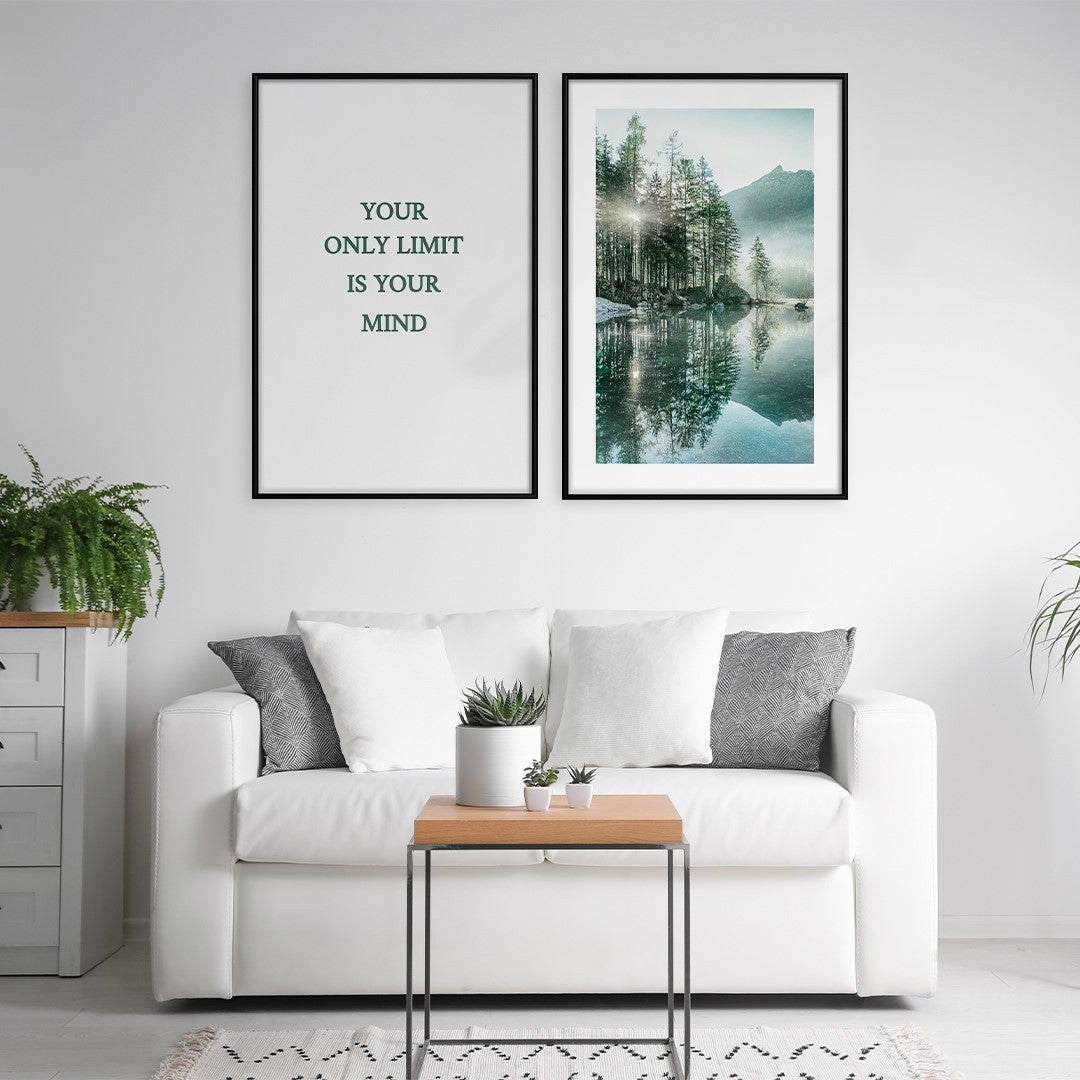 A living room with a couch and a table. Two nature posters hang on the wall behind the couch. The motivational quote "Your only limit is your mind" is printed on one of two framed posters.