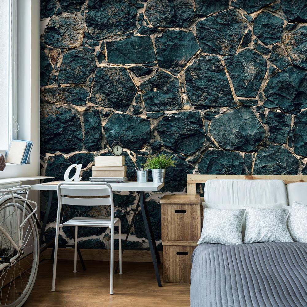 a beautiful stone design wallpaper mural in a bedroom, there's a small desk and a chair next to a bed