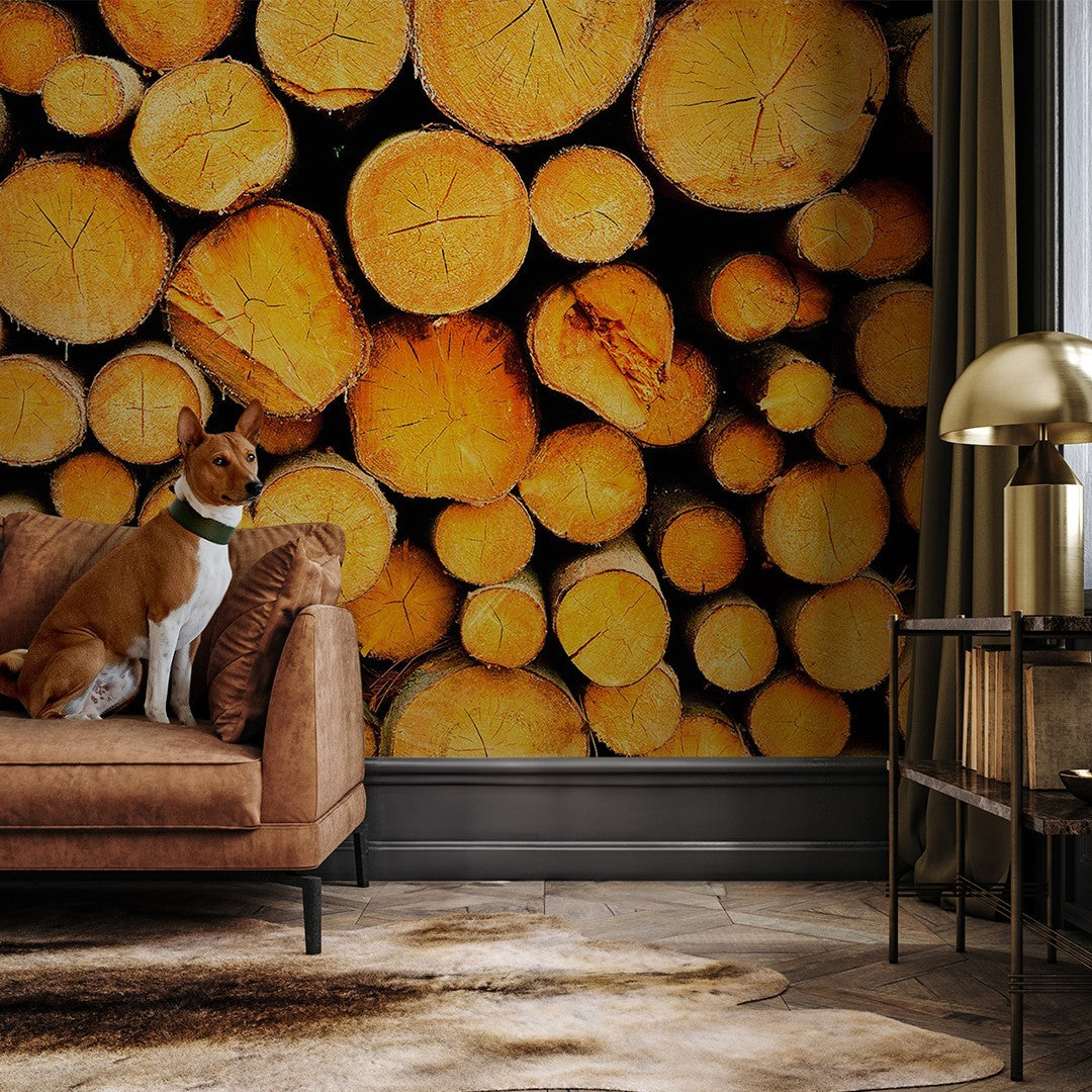 a dog sitting on a sofa in a living room and there's a wooden wallpaper mural that look like chopped wood in a well lit room