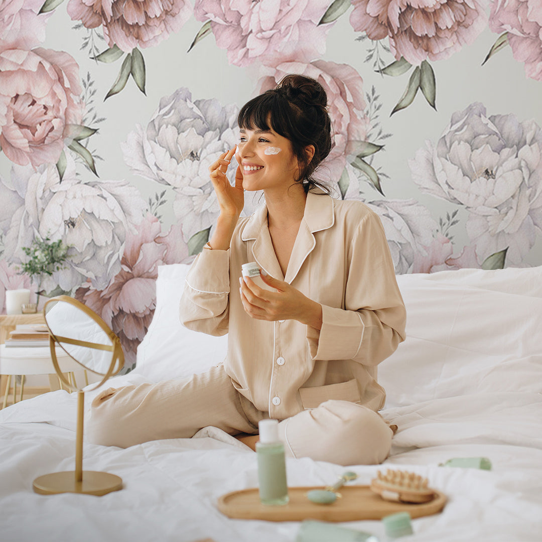 a woman doing her daily skincare routine in her bedroom, the floral wallpaper just made the room more elegant and stunning