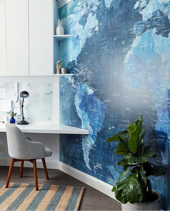 A blue world map wallpaper mural in a home office, specially designed for Cybersecurity analysts, the desk is attached to the wall