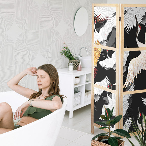 a woman relaxing on a bathroom with a shoji screen next to it and a wallpaper mural with beautiful feng shui design behind her 