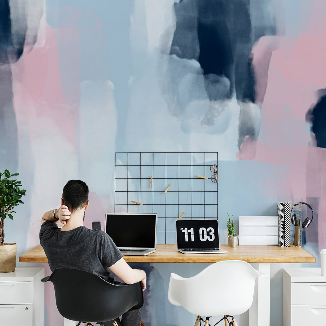 a man working on their home office room next to a beautiful geometric wall mural