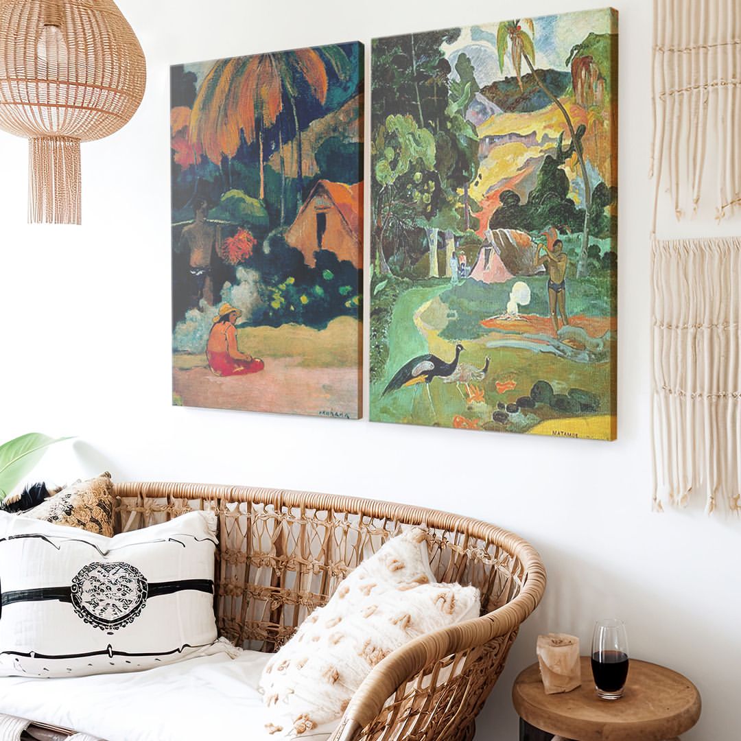 two canvas wall arts hanging on a living room next to a cozy rattan sofa